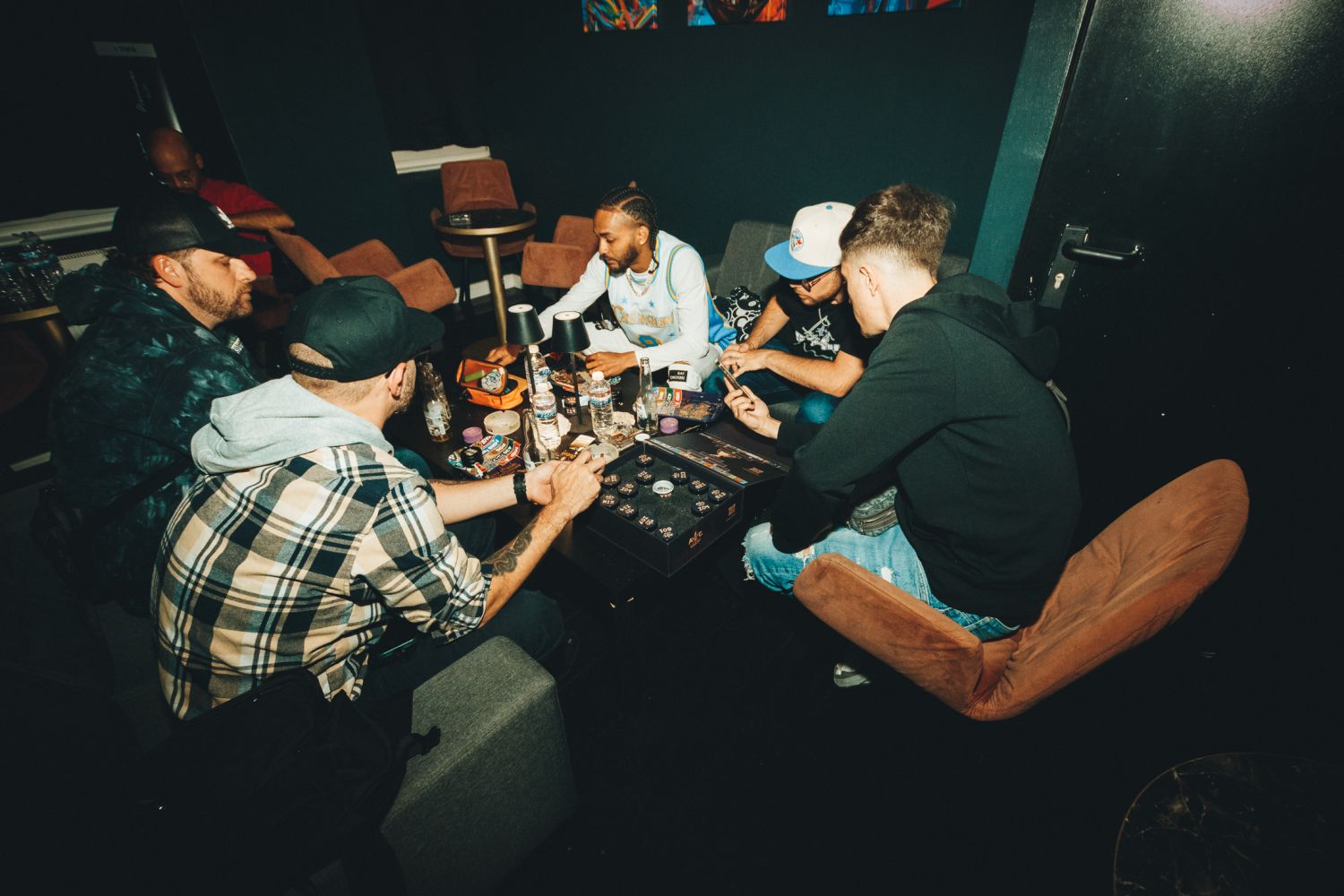 roup of judges gathered around a low table sampling cannabis entries in a lounge at the Autoflower World Cup 2026