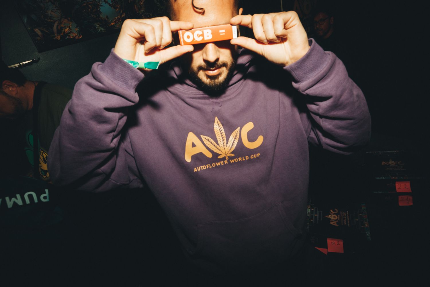 Arnau Tango in an Autoflower World Cup hoodie holding OCB rolling papers at the 2026 event