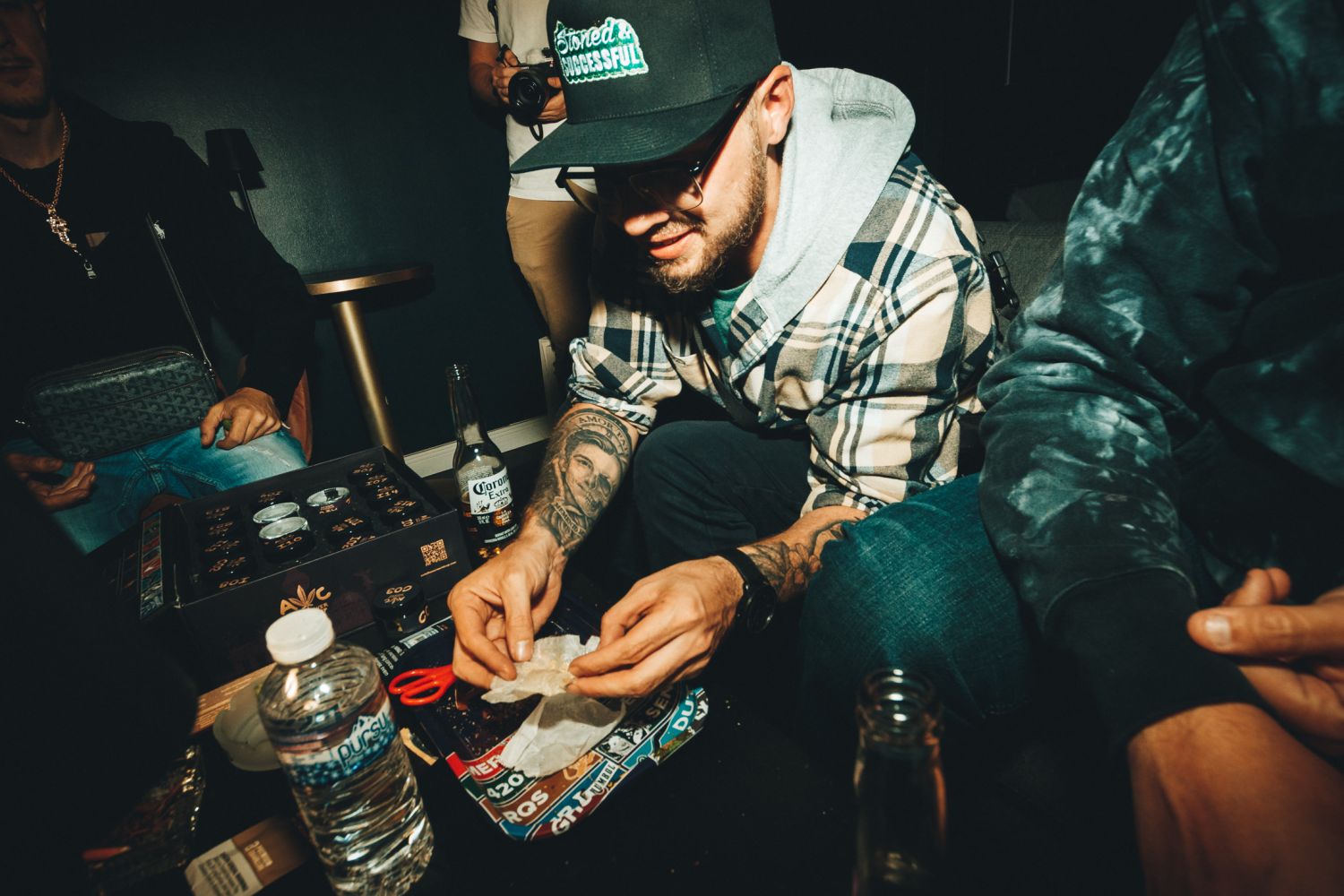 Rob CLV rolling cannabis on a tray beside AAC judging jars at the Autoflower World Cup in Berlin 2026