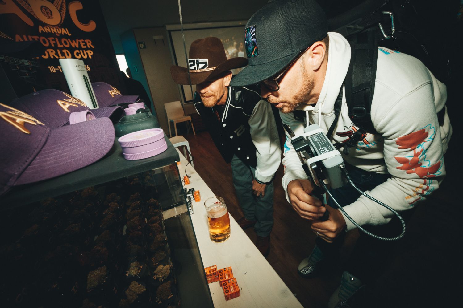 Two judges examining jarred cannabis samples at the Autoflower World Cup 2026 display in Berlin