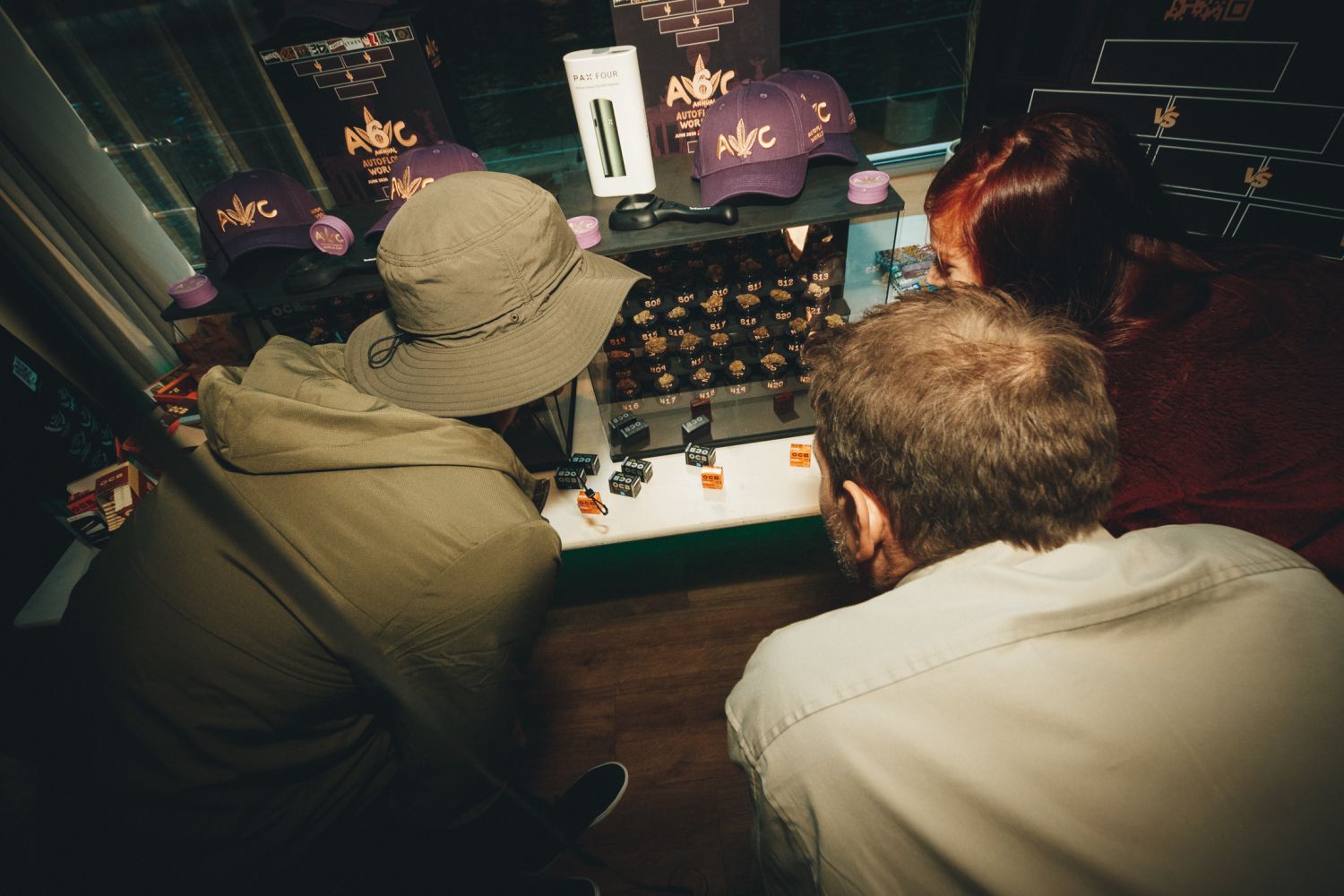 Attendees examining numbered cannabis strain samples at Autoflower World Cup competition display