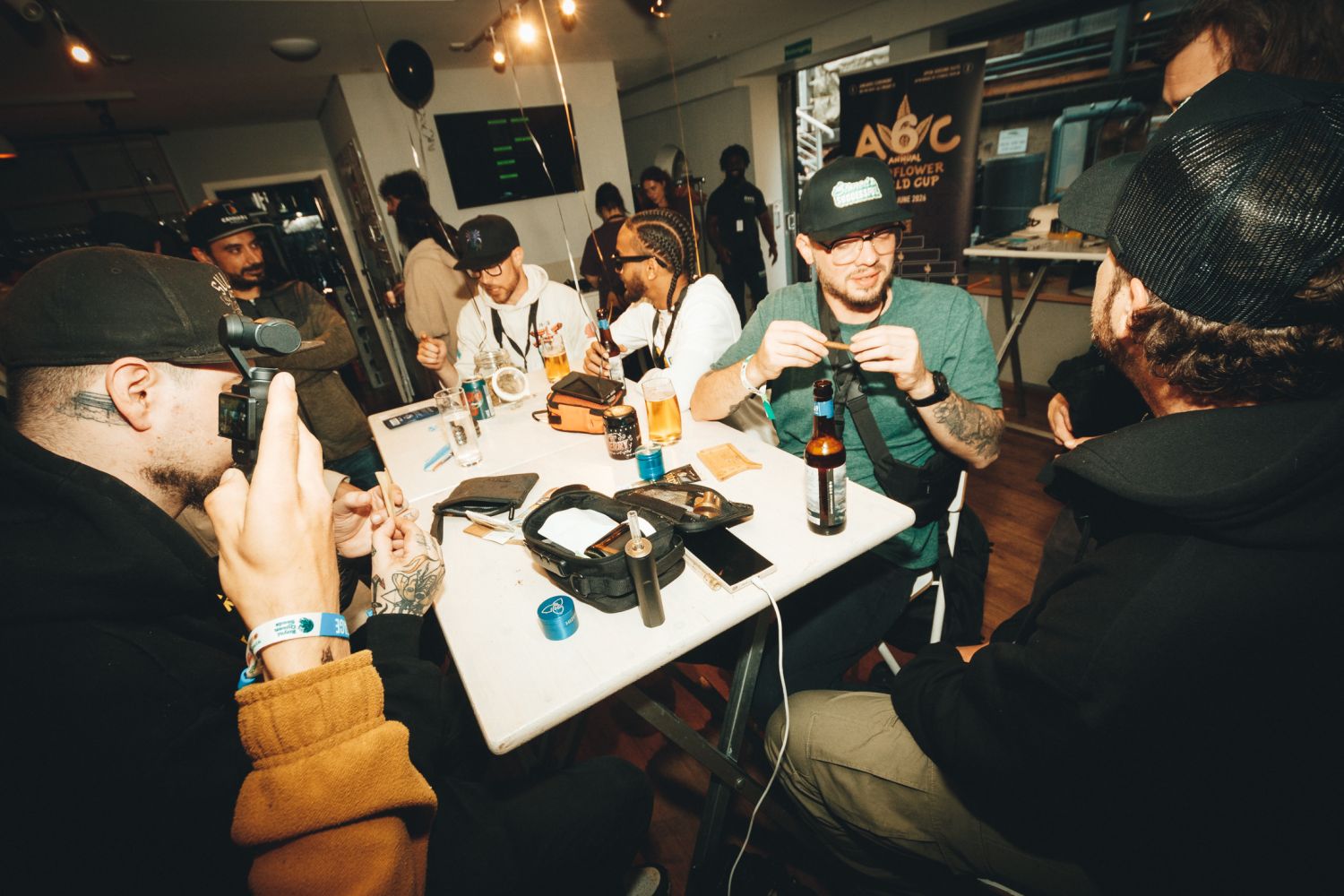 Growers and breeders rolling up around a table at the Autoflower World Cup 2026 in Berlin, A6C banner behind them